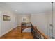 Upstairs landing with hardwood floors, wrought iron railing, and natural light at 10531 Pontofino Cir, Trinity, FL 34655