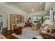 Open concept living room with built-in shelving, ceiling fan, and hardwood flooring at 10531 Pontofino Cir, Trinity, FL 34655