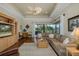 Spacious living room with wood floors, a ceiling fan, and a large built in television at 10531 Pontofino Cir, Trinity, FL 34655