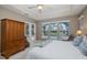 Cozy main bedroom with backyard views, carpeted floors, tray ceiling and comfortable furniture at 10531 Pontofino Cir, Trinity, FL 34655