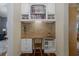 Built in office with wood desk, storage and shelving and views into the living room at 10531 Pontofino Cir, Trinity, FL 34655
