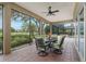 Inviting outdoor dining area on a screened patio with views of the lush backyard at 10531 Pontofino Cir, Trinity, FL 34655