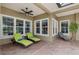 Relaxing patio with lounge chairs, ceiling fan, and multiple windows offering natural light at 10531 Pontofino Cir, Trinity, FL 34655