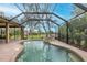 Backyard pool and spa with screened enclosure, offering a private outdoor oasis at 10531 Pontofino Cir, Trinity, FL 34655