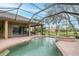 Inviting screened-in pool with a connected spa and brick-paved patio, perfect for outdoor relaxation and entertainment at 10531 Pontofino Cir, Trinity, FL 34655
