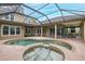 Aerial view of the home's screened-in pool, spa, and outdoor living spaces at 10531 Pontofino Cir, Trinity, FL 34655