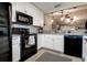 Well-equipped kitchen with sleek black appliances, white cabinets, and stone countertops at 10670 43Rd N St # 204, Clearwater, FL 33762