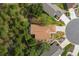 Overhead view of a home surrounded by trees, featuring a well-manicured lawn and landscaping at 11404 Inman Ct, Spring Hill, FL 34609
