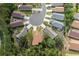 An aerial shot showing the property with mature landscaping, a circular driveway, and the surrounding neighborhood at 11404 Inman Ct, Spring Hill, FL 34609