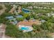 Aerial view of the community clubhouse with pool and tennis courts at 11404 Inman Ct, Spring Hill, FL 34609