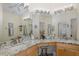 Elegant bathroom featuring double sinks, granite countertops, and bright vanity lighting at 11404 Inman Ct, Spring Hill, FL 34609
