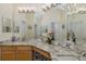 Elegant bathroom featuring double sinks, granite countertops, and bright vanity lighting at 11404 Inman Ct, Spring Hill, FL 34609