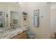 Bright bathroom featuring a granite countertop vanity and decorative accents at 11404 Inman Ct, Spring Hill, FL 34609