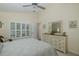 Spacious bedroom with a large dresser, and plantation shutters on the window at 11404 Inman Ct, Spring Hill, FL 34609
