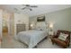 Light and airy bedroom with a comfortable bed, ceiling fan, and view to ensuite bathroom at 11404 Inman Ct, Spring Hill, FL 34609
