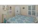 Comfortable bedroom with matching decor, bright natural light, and shuttered windows at 11404 Inman Ct, Spring Hill, FL 34609