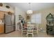 Breakfast nook featuring a round table, stainless steel refrigerator, and chandelier at 11404 Inman Ct, Spring Hill, FL 34609