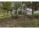Exterior view of a home with a screened lanai and mature landscaping at 11404 Inman Ct, Spring Hill, FL 34609