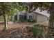 Exterior view of a home with mature trees and landscaped yard at 11404 Inman Ct, Spring Hill, FL 34609