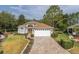Charming single-story home featuring a well-manicured lawn and a brick paver driveway at 11404 Inman Ct, Spring Hill, FL 34609