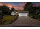 Inviting single-story home with brick paver driveway and vibrant sunset at 11404 Inman Ct, Spring Hill, FL 34609
