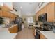 Bright kitchen with stainless steel appliances, light wood cabinets, and an eat-in area at 11404 Inman Ct, Spring Hill, FL 34609