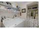 Functional laundry room equipped with shelving, a washer, a dryer, and a sink at 11404 Inman Ct, Spring Hill, FL 34609
