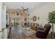 Bright living room with high ceilings, ceiling fan, and sliding doors to a screened-in porch at 11404 Inman Ct, Spring Hill, FL 34609