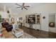 Comfortable living room with a decorative rug, white entertainment center, and view to front entrance at 11404 Inman Ct, Spring Hill, FL 34609