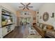Cozy living room with a decorative rug, white entertainment center, and sliding glass doors to outside at 11404 Inman Ct, Spring Hill, FL 34609