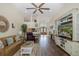 Open-concept living room with a decorative rug, white entertainment center, and view to front entrance at 11404 Inman Ct, Spring Hill, FL 34609