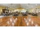 Spacious meeting room with hardwood floor, fireplace, bar, and seating arrangements for large gatherings at 11404 Inman Ct, Spring Hill, FL 34609