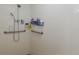 Accessible tiled shower with safety bars and shelving for toiletries at 11404 Inman Ct, Spring Hill, FL 34609