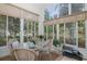 Relaxing sunroom with dining set, lots of windows and a view of the backyard at 11404 Inman Ct, Spring Hill, FL 34609
