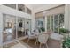 Enclosed sunroom with dining set, lots of windows and a view of the backyard at 11404 Inman Ct, Spring Hill, FL 34609