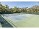 Well-maintained tennis courts enclosed with dark fencing and benches, offering a great recreational space at 11404 Inman Ct, Spring Hill, FL 34609