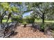 Beautiful backyard with a patio set and lush greenery, offering a tranquil space for outdoor enjoyment at 1142 Wolford Dr, Trinity, FL 34655