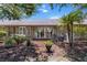 Serene backyard featuring a mulched area, patio furniture, and lush landscaping, perfect for outdoor relaxation at 1142 Wolford Dr, Trinity, FL 34655