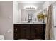 Stylish bathroom featuring a double vanity with modern sinks, dark cabinetry, and elegant fixtures at 1142 Wolford Dr, Trinity, FL 34655