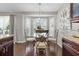 Bright breakfast nook featuring a glass table set, bay windows with shutters, and modern light fixture at 1142 Wolford Dr, Trinity, FL 34655