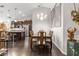 Elegant dining room featuring a chandelier, seating for six, and dark wood floors at 1142 Wolford Dr, Trinity, FL 34655