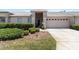 Inviting home exterior featuring a well-manicured lawn and an attached garage, creating a welcoming curb appeal at 1142 Wolford Dr, Trinity, FL 34655