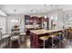 Spacious kitchen featuring a large island with bar seating, granite countertops, and dark wood cabinets at 1142 Wolford Dr, Trinity, FL 34655
