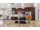 Kitchen featuring a granite counter top, stainless steel appliances and dark wood cabinets at 1142 Wolford Dr, Trinity, FL 34655