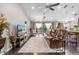 Spacious living room with leather seating, ceiling fans, and plenty of natural light at 1142 Wolford Dr, Trinity, FL 34655