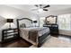 Bright main bedroom featuring a decorative ceiling fan and matching mirrored night stands at 1142 Wolford Dr, Trinity, FL 34655