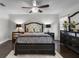 Spacious main bedroom featuring a decorative ceiling fan, dresser and matching mirrored night stands at 1142 Wolford Dr, Trinity, FL 34655