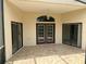 Charming back patio with tiled floor, French doors, and ample natural light, perfect for outdoor entertaining at 11520 Lounds Ct, New Port Richey, FL 34654