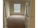 Cozy bedroom featuring neutral paint, soft carpet, and a bright window at 11520 Lounds Ct, New Port Richey, FL 34654