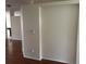 Inviting hallway featuring wood floors, neutral paint, and smooth walls connecting to the living spaces at 11520 Lounds Ct, New Port Richey, FL 34654